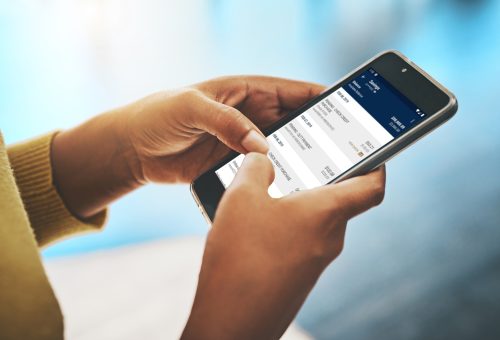 Cropped shot of a businesswoman using a mobile phone in an office