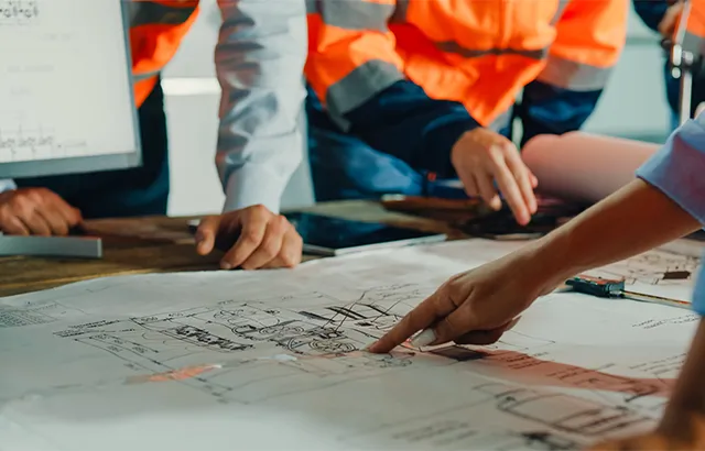 Lady pointing at construction plans