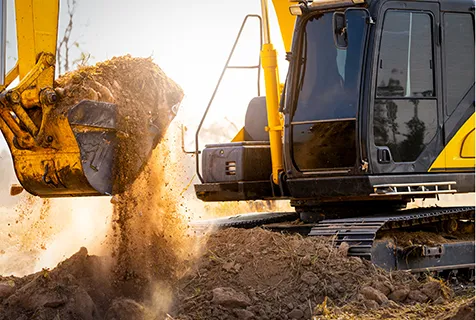 Construction vehicle picking up dirt